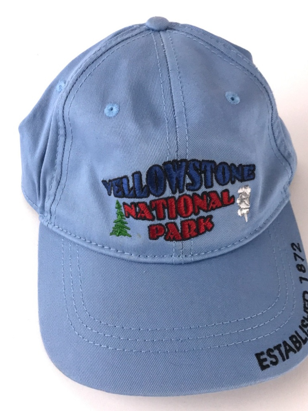 Yellowstone National Park Established 1872 light blue hat pine tree geyser